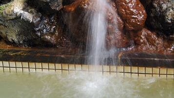 A waterfall feature with rocks and a tiled border.