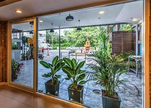 Enjoy the vibrant street scene from the comfort of your room, with a view of the bustling street through large glass doors.