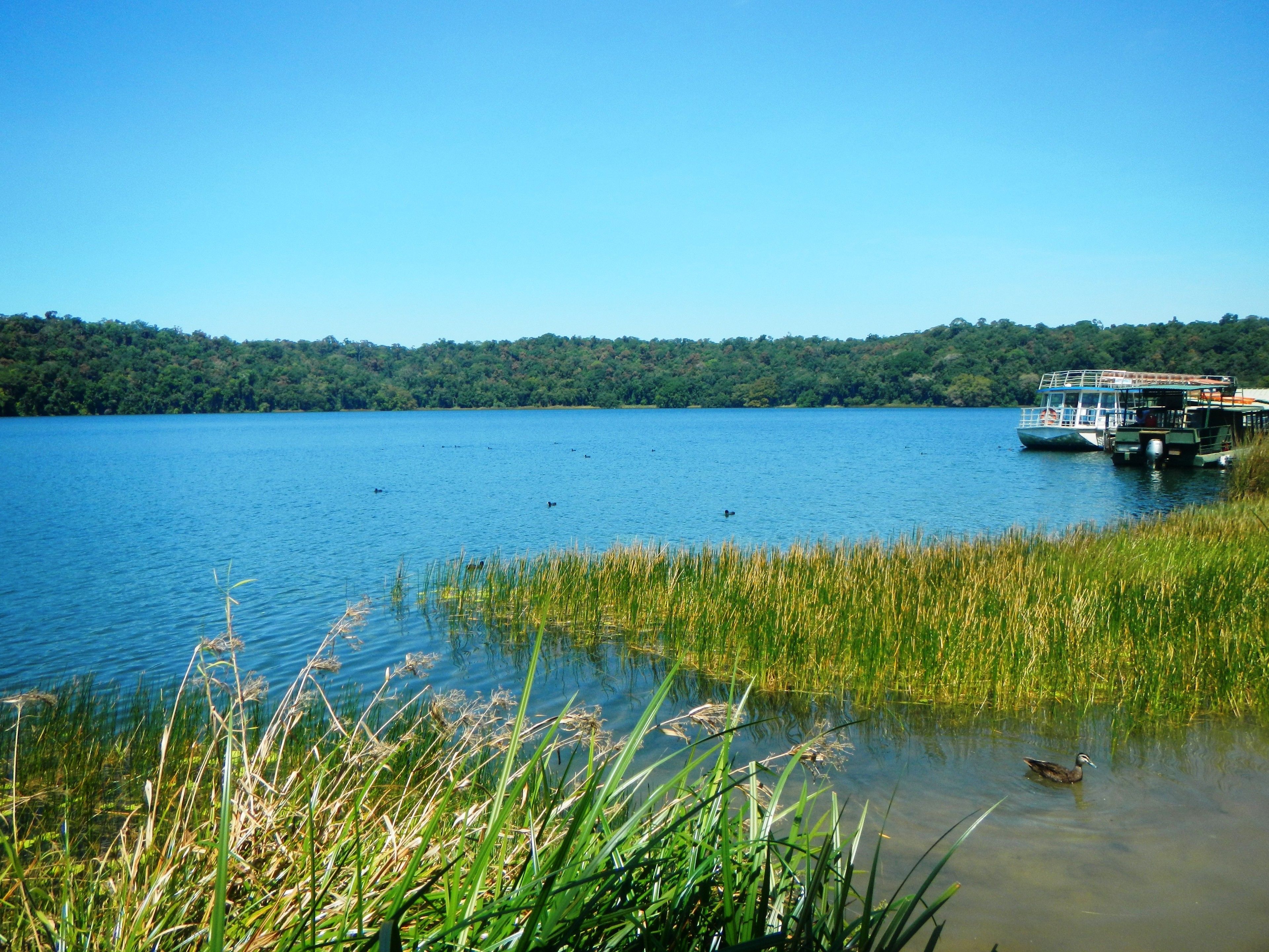 A lake with a boat docked on the right side.