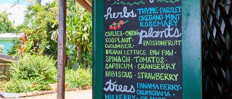 A sign listing garden herbs and plants.
