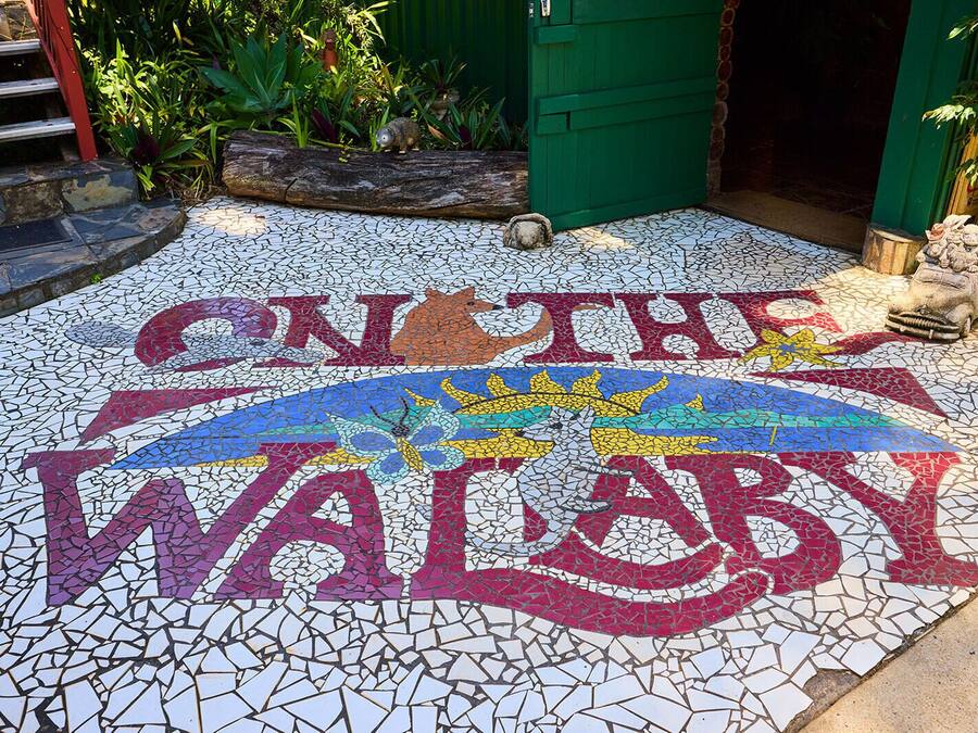 A mosaic with the text "ON THE WALBY" and a stylized sun design.