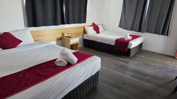 Deluxe Studio | Premium bedding, desk, blackout drapes, iron/ironing board