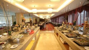 A buffet setup with multiple food stations and a long counter. - Huashan Mountain International Hotel (Xi'an)