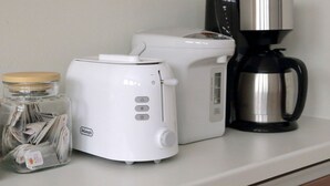 A kitchen counter with a coffee maker, a toaster, and a jar of tea bags. - OCHO Guest House - Hostel (Sapporo)