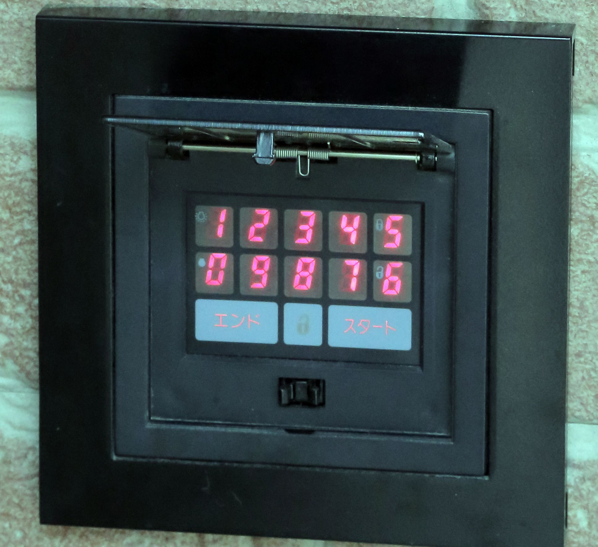 A digital lock with a keypad and a small display.