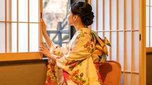 A traditional Japanese room with tatami flooring, a low table with a tea set, and a sliding shoji screen door. - KumoMachiya Takasegawa (Kyoto)