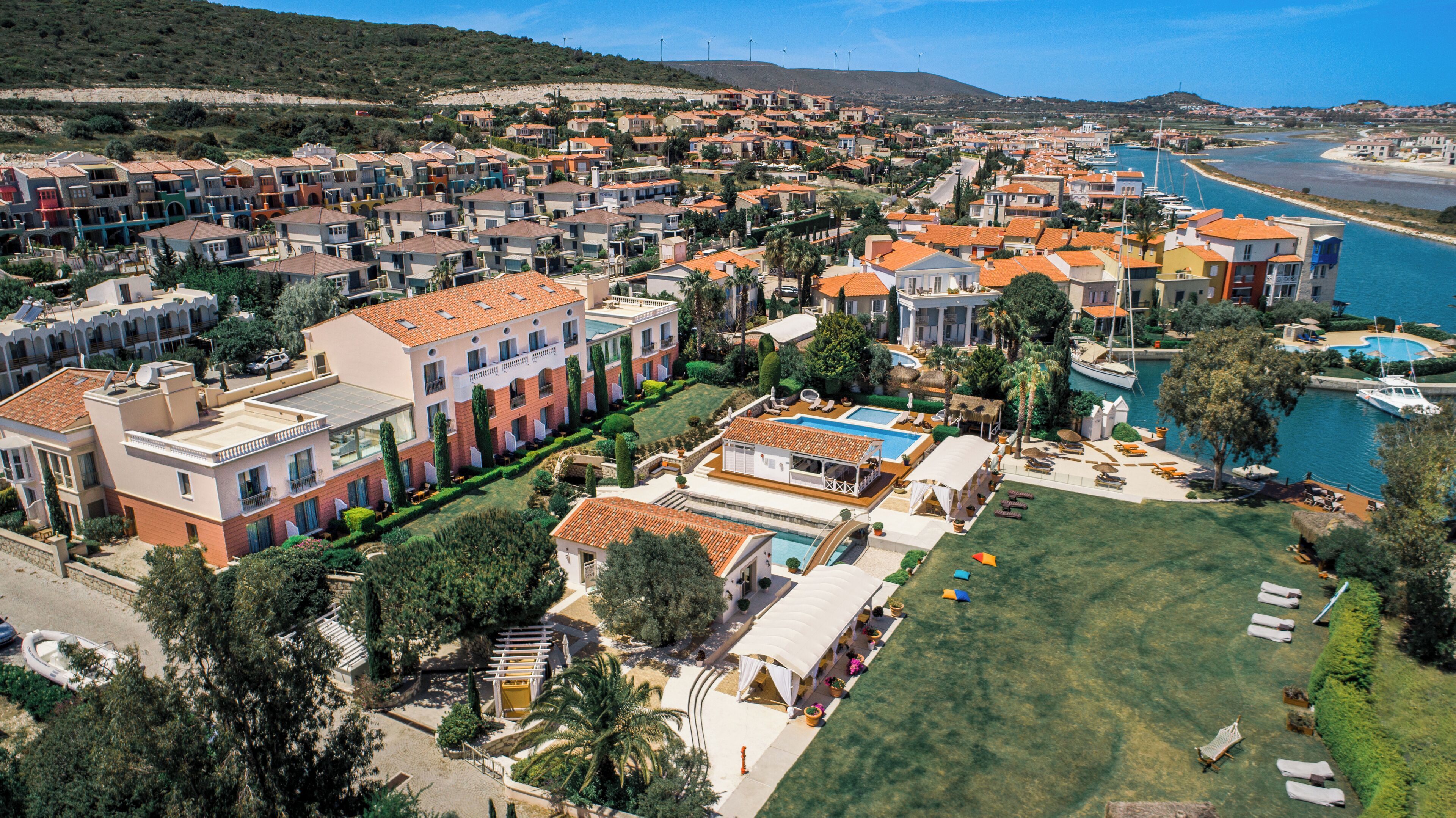 A coastal residential area with multiple houses, a swimming pool, and a marina.