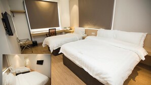 A hotel room with two beds, a desk, a chair, a TV, and a window with blinds. - Extreme Boutique Hotel (Kluang)