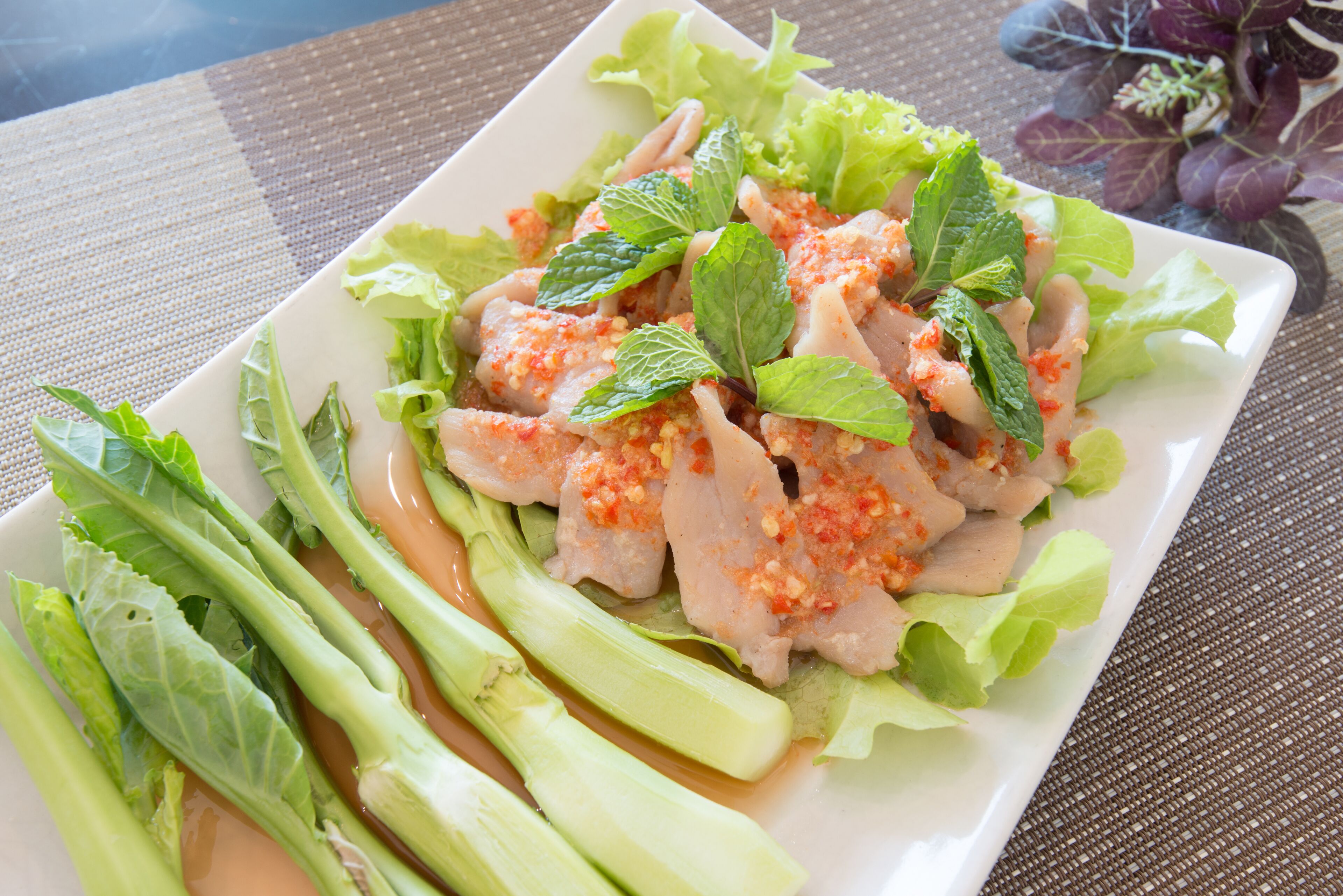 A plate of food with lettuce and a sauce.