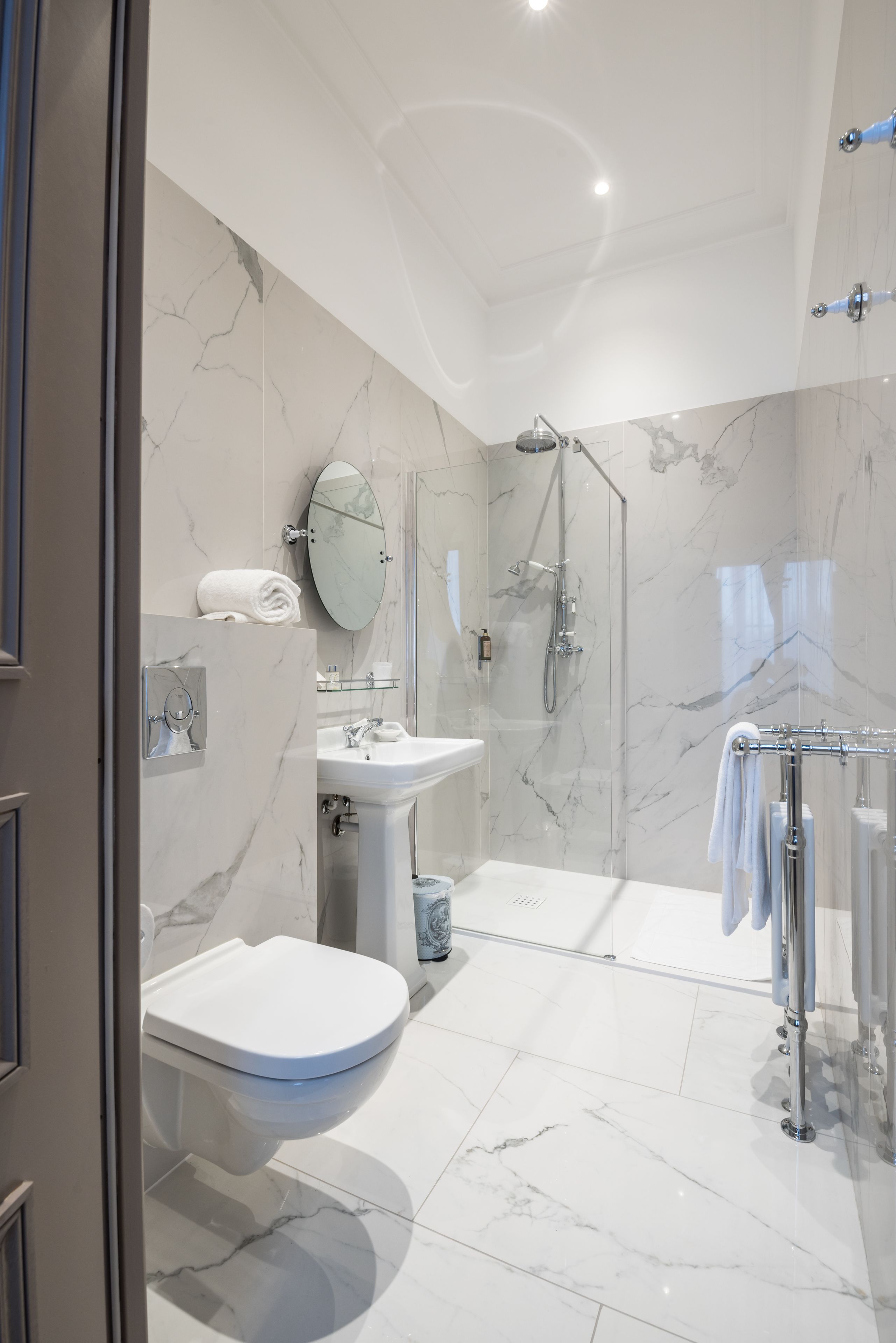 A modern bathroom with a toilet, sink, and shower area.