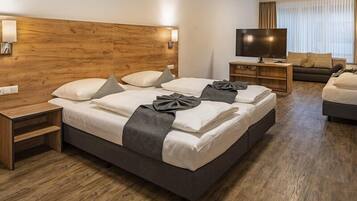 Family Room | Premium bedding, desk, laptop workspace, blackout drapes