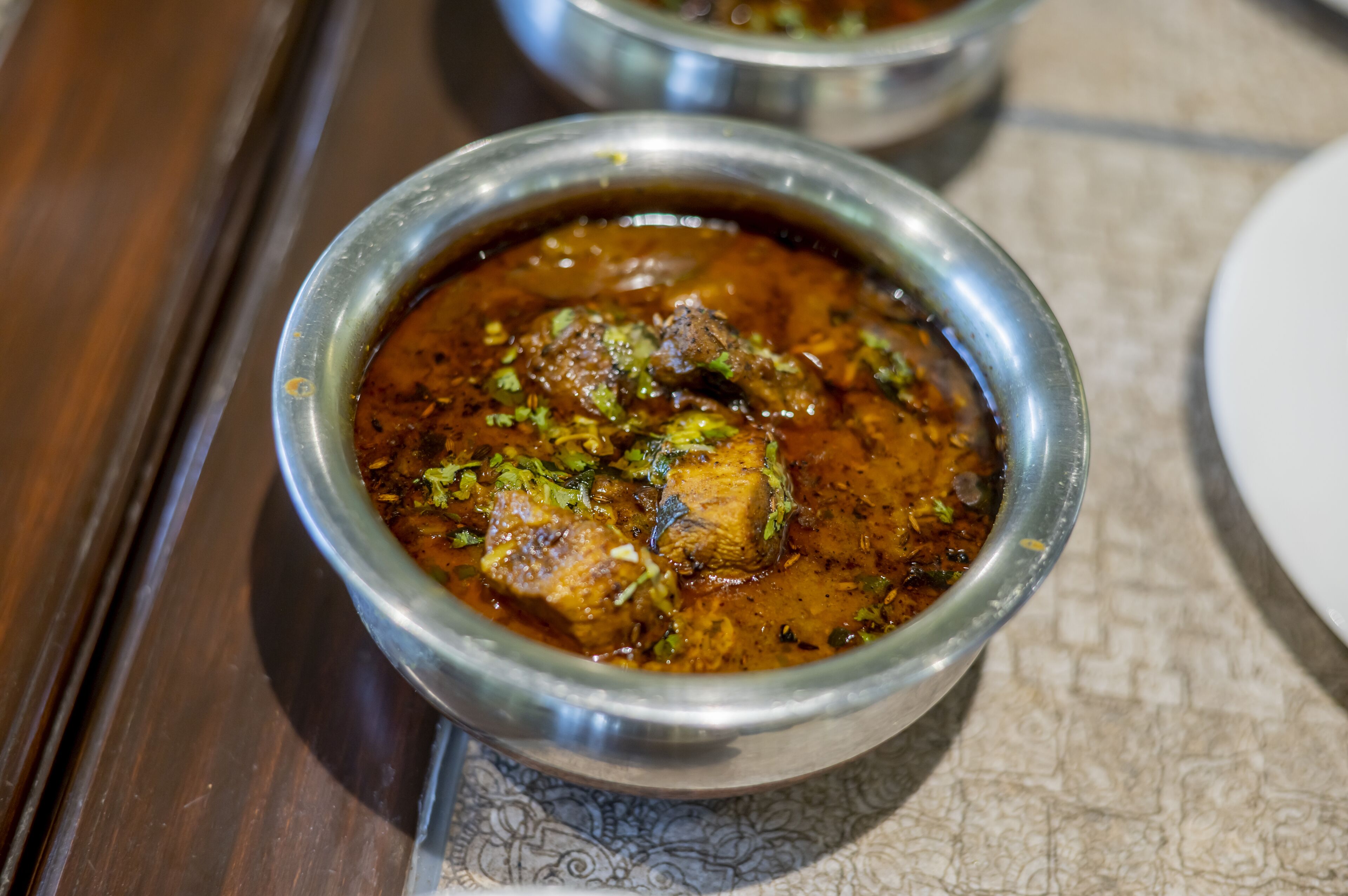 Un plat de curry avec de la viande et une garniture.
