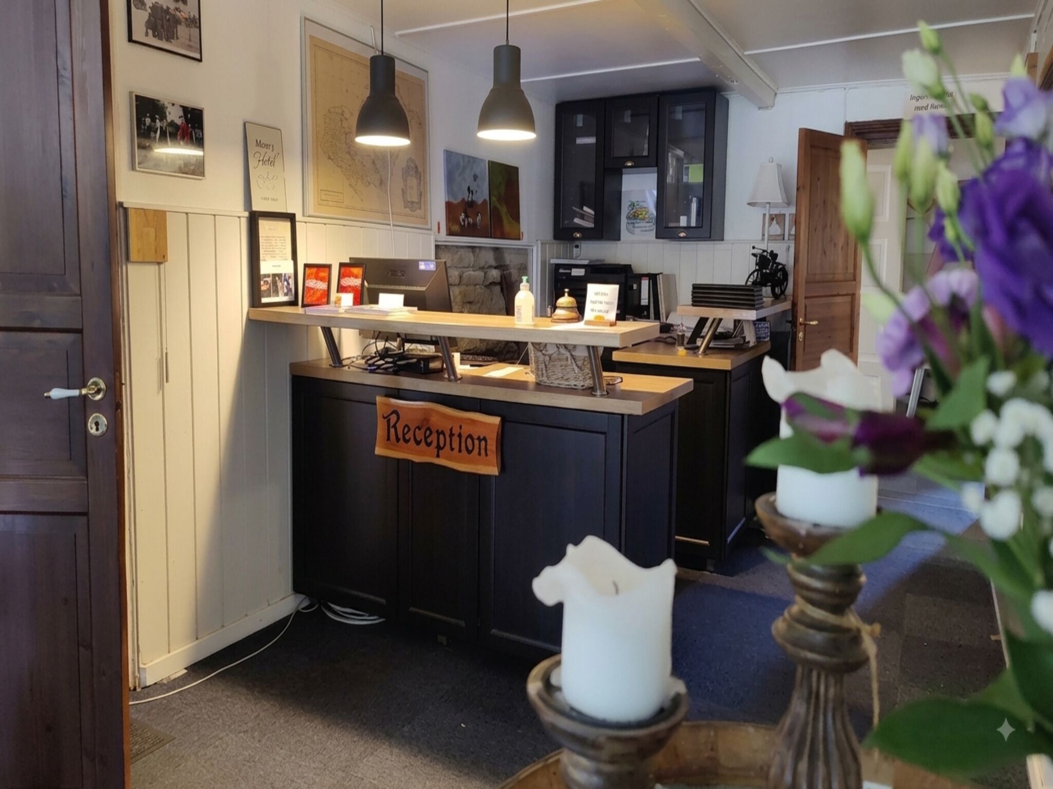 A reception area with a sign, a desk, and a counter.