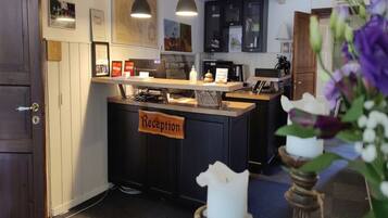 A reception area with a sign, a desk, and a counter.