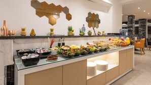 A buffet with various food items and a modern interior design. - Hôtel Étoile du Nord (Tangier)