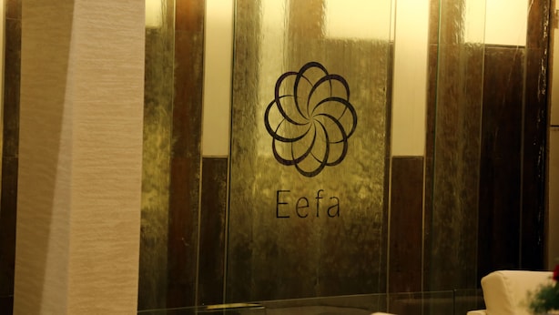 A wall with a logo and the word "Eefa" in a modern, reflective surface. - Hotel EEFA (Belagavi)
