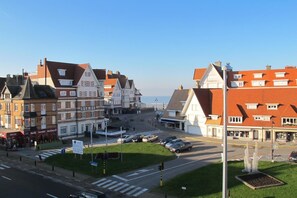 A hotel with a traditional European architectural style, featuring a prominent entrance with a red awning and a signboard. - Vakantiecentrum Zeelinde (De Haan)