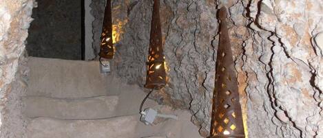 A staircase with stone steps and metal railings, leading to a higher level.