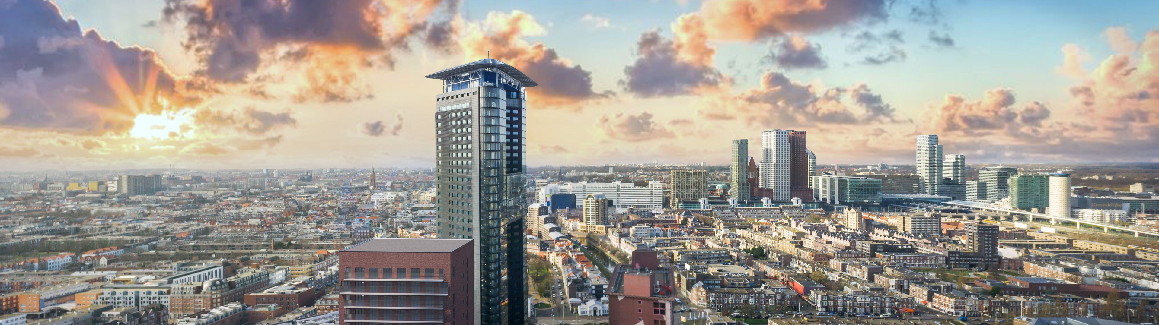 A cityscape with modern high-rise buildings, a prominent tower, and a mix of residential and commercial structures.