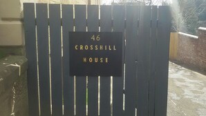 A black metal gate with a sign that reads "46 CROSSHILL HOUSE". - Crosshill House (Glasgow)