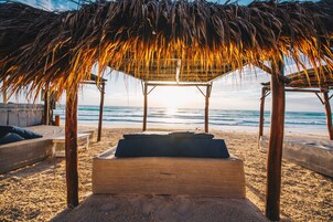 On the beach, white sand, free beach cabanas, sun loungers