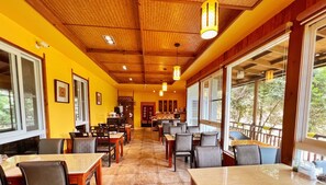 A restaurant with wooden ceiling and walls, large windows, and a long counter. - I-Think Resort (Ren'ai)