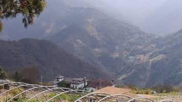 A mountainous landscape with a few buildings at the base.