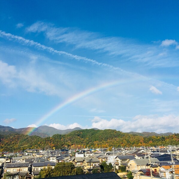 A residential area with houses, a clear sky, and a rainbow. - Tsubame-ya - Hostel (Kyoto)