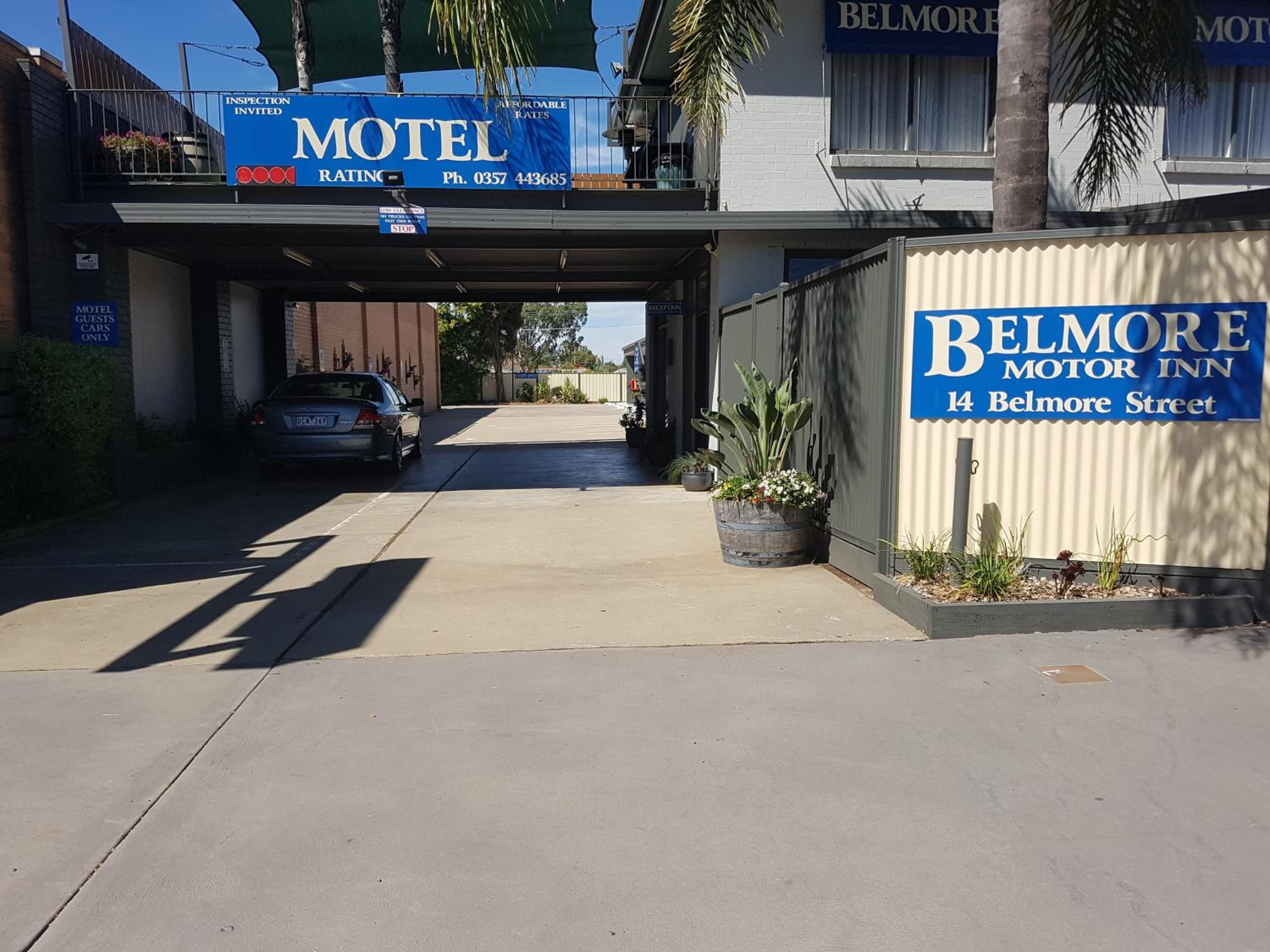 A motel with a sign indicating it is a Belmore Motor Inn, located at 14 Belmore Street.