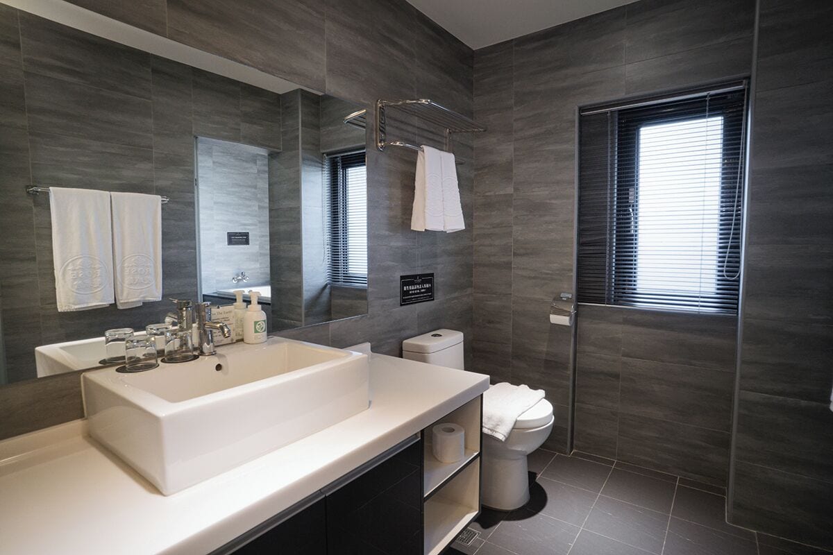 deluxe double room, 1 king bed | bathroom | hair dryer, slippers, towels