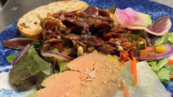A plate with a variety of food items including bread, meat, and vegetables.