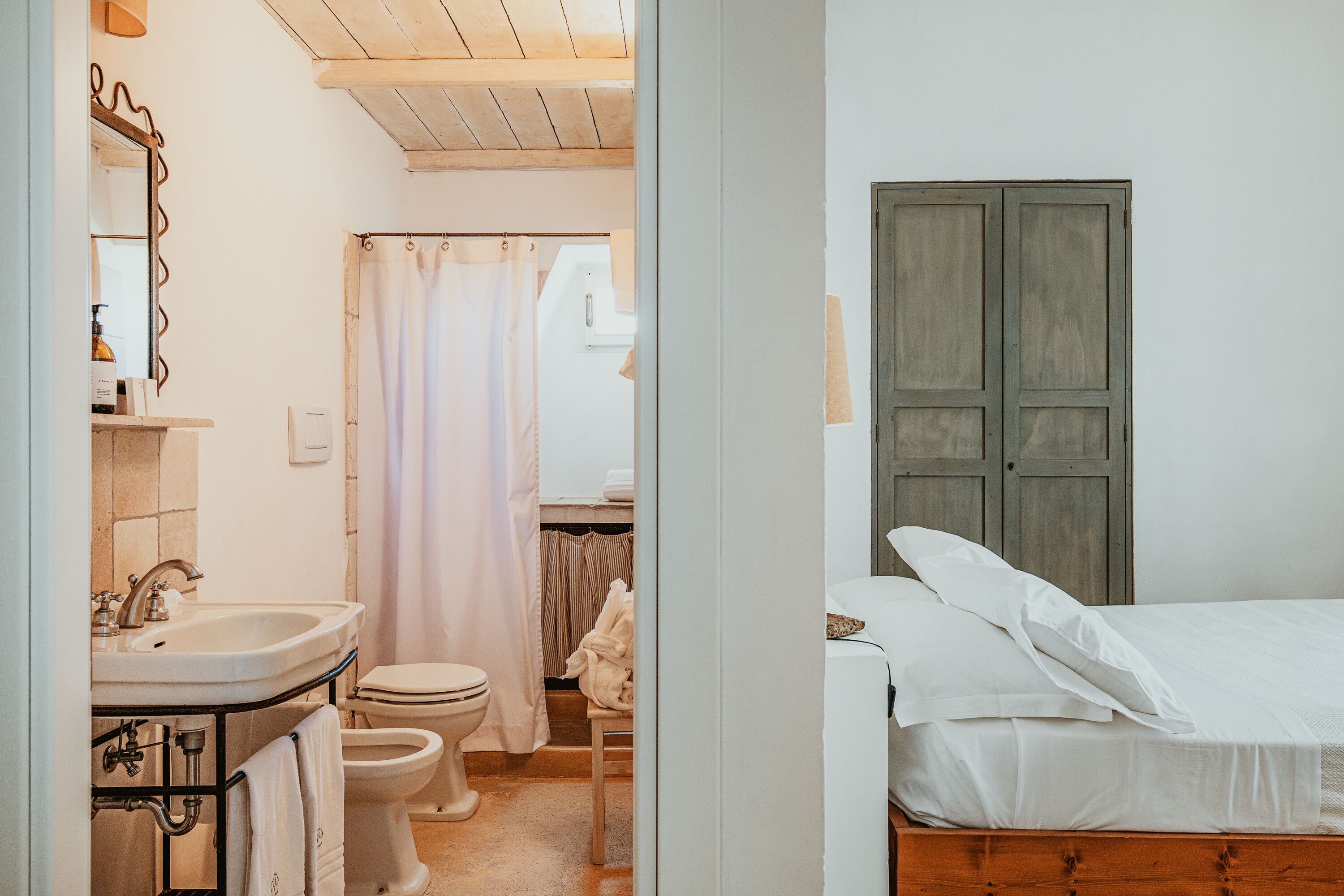 A bathroom with a sink, toilet, and shower curtain.