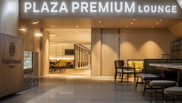 The entrance to Plaza Premium Lounge with a modern interior, featuring a reception desk, seating area, and a view into the lounge space. - Plaza Premium Lounge Terminal 2 Zone A (Taoyuan City)