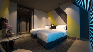A modern hotel room with two beds, a small table with a vase, and a unique geometric wall design. - Plaza Premium Lounge Terminal 2 Zone A (Taoyuan City)