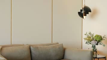 A modern living room with a sofa, coffee table, and a lamp.