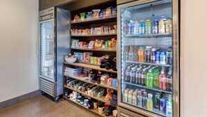 A self-service beverage and snack vending area with refrigerated and non-refrigerated options. - MainStay Suites Near Denver Downtown (Denver)