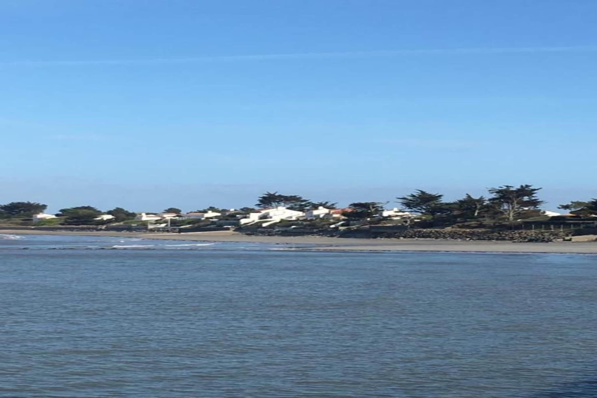A coastal view with houses along the shoreline.