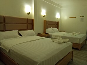 A hotel room with two beds, each with a headboard and bedside tables. - Meaco Hotel - Anilao (Mabini)