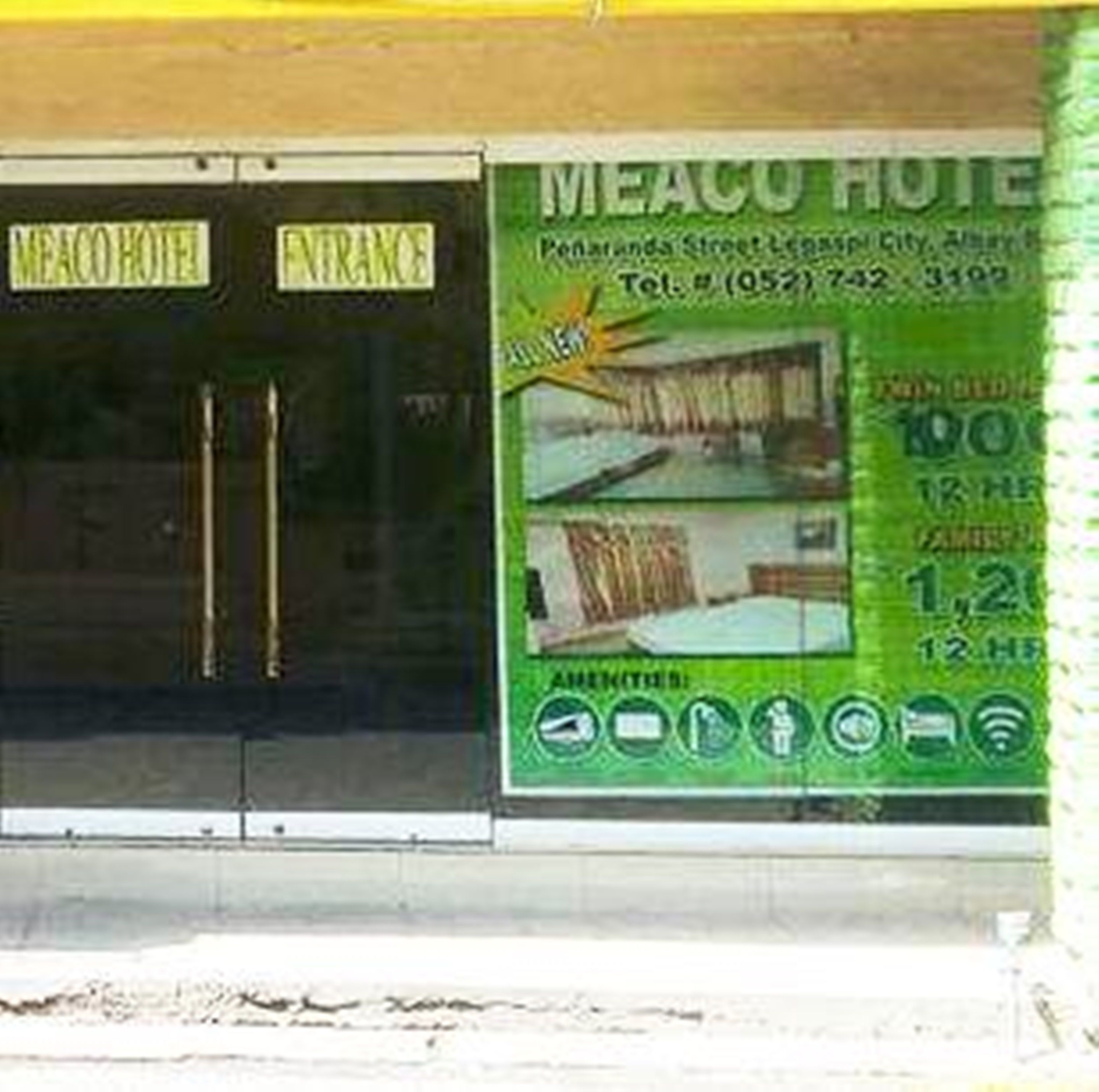 A hotel entrance with a sign reading "MEACO HOTEL" and "ENTRANCE".