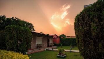 A brick house with a patio and a lawn.
