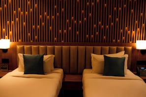 A hotel room with two beds, a wooden slatted headboard, and bedside lamps. - Dreamland Gold Resort (Tilottama)