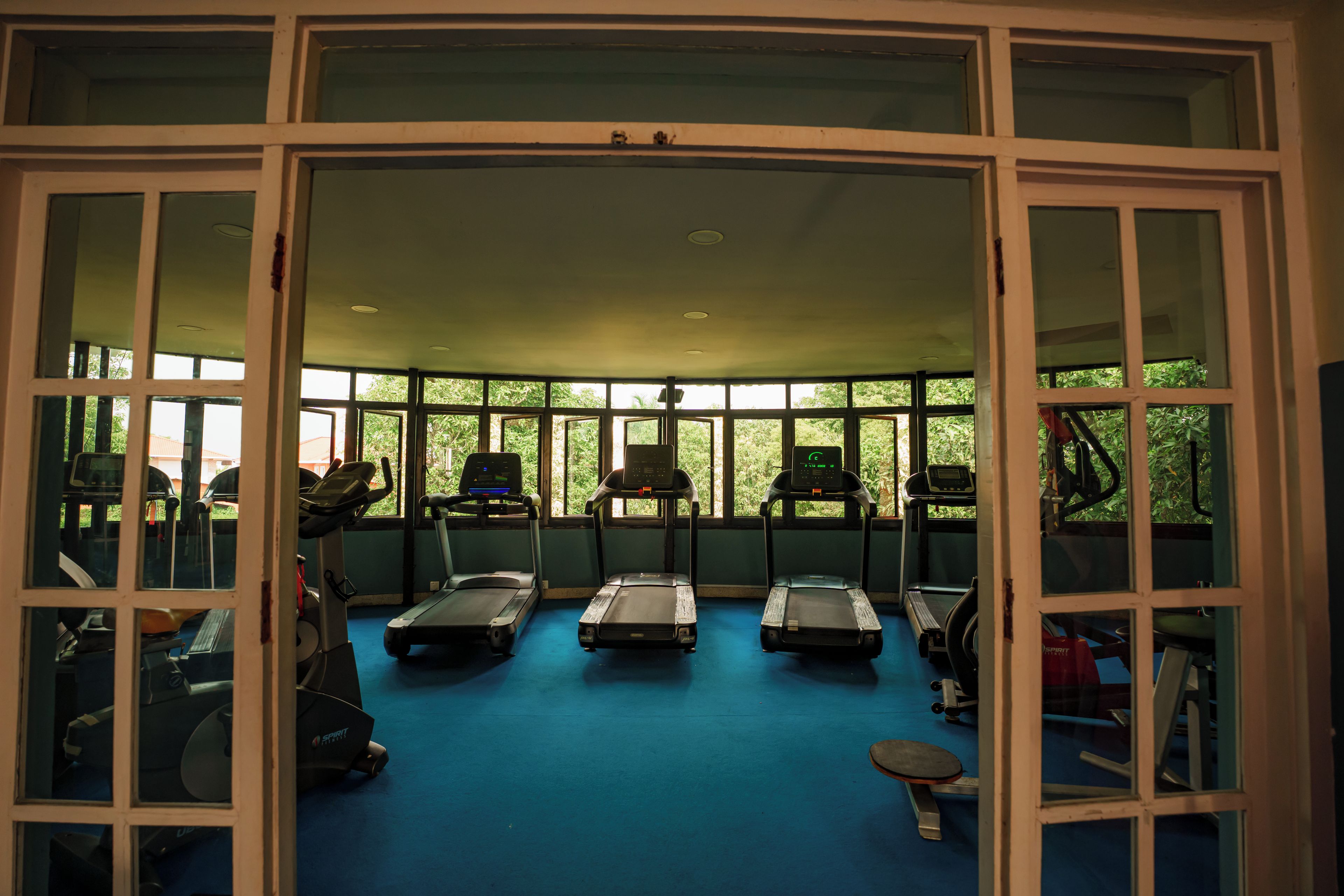 A gym with treadmills, stationary bikes, and exercise equipment.