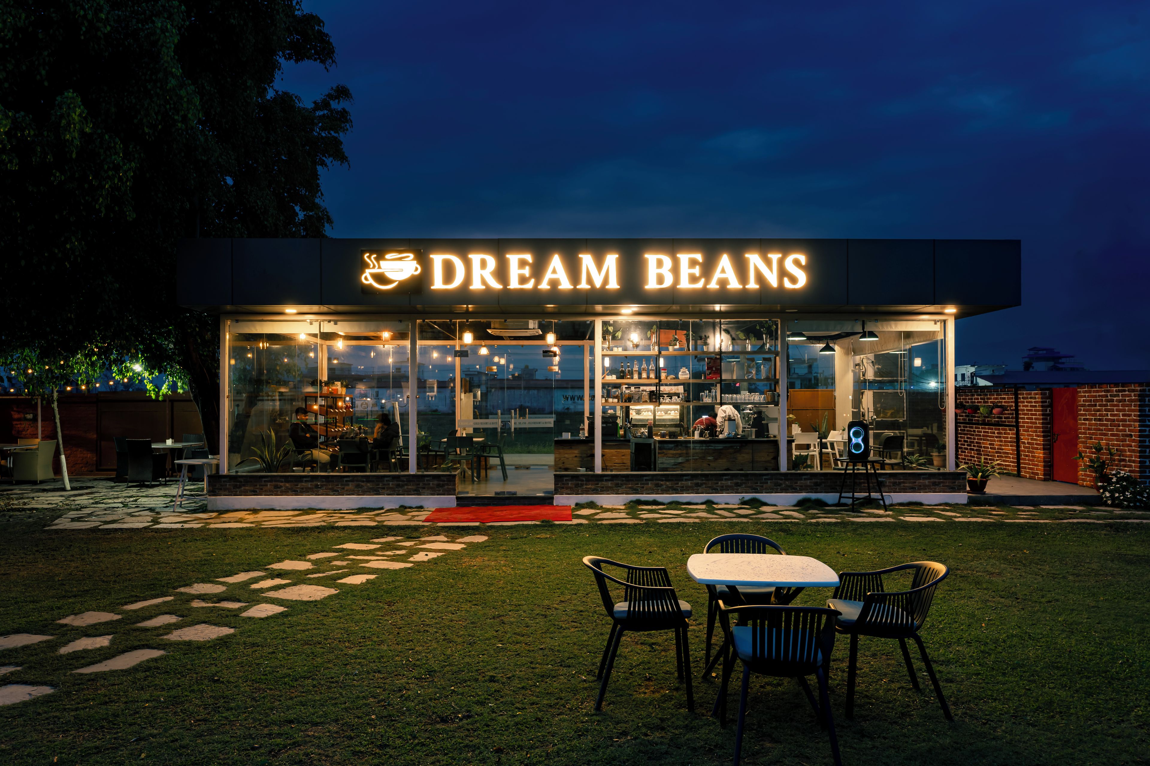 A restaurant named 'Dream Beans' with outdoor seating and a visible kitchen area.