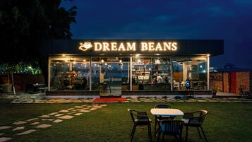 A restaurant named 'Dream Beans' with outdoor seating and a visible kitchen area.