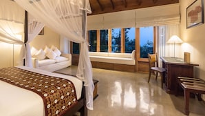 A bedroom with a four-poster bed, a desk, and a chair. - Kings Pavilion (Kandy)