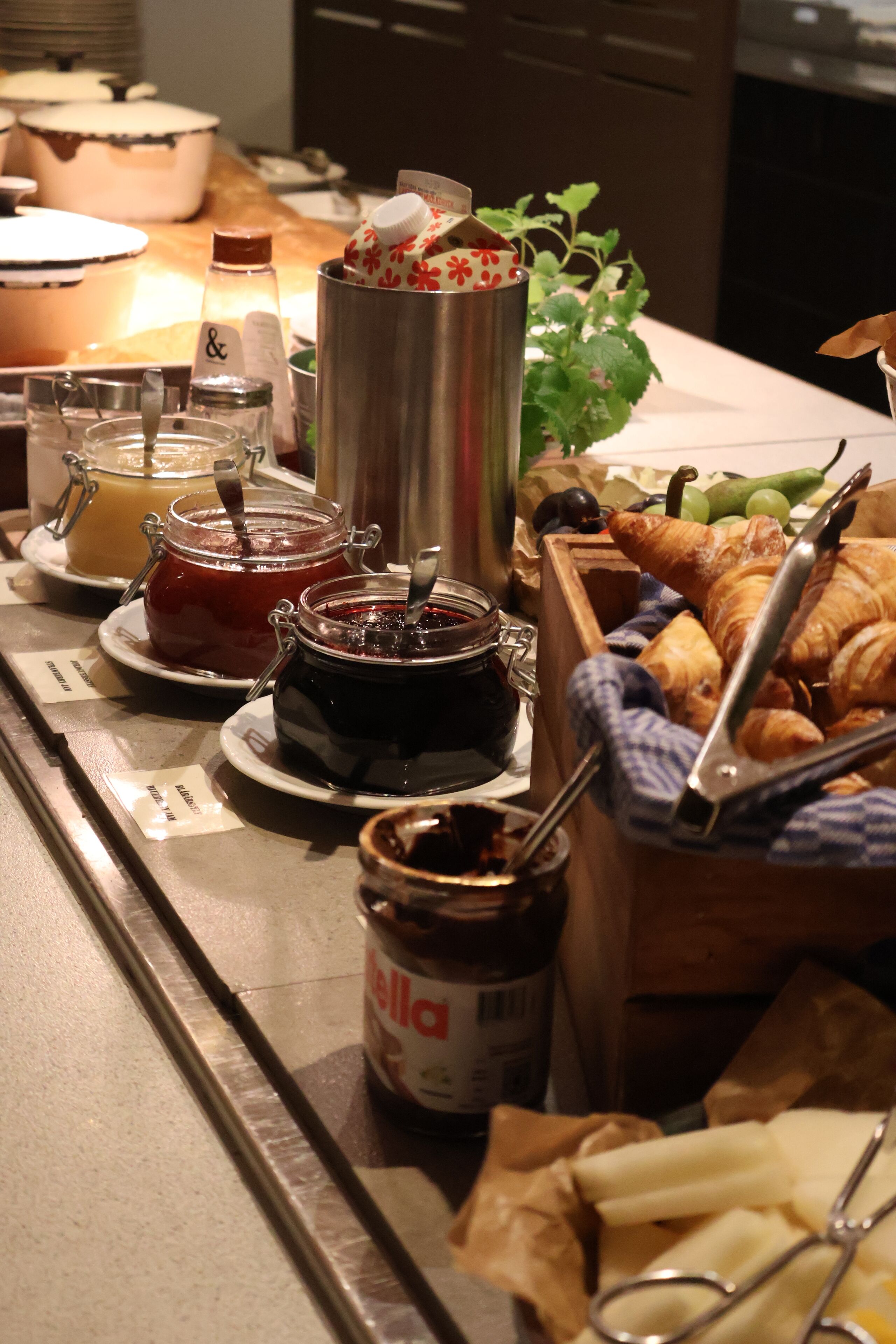 A breakfast buffet with various food items and condiments.