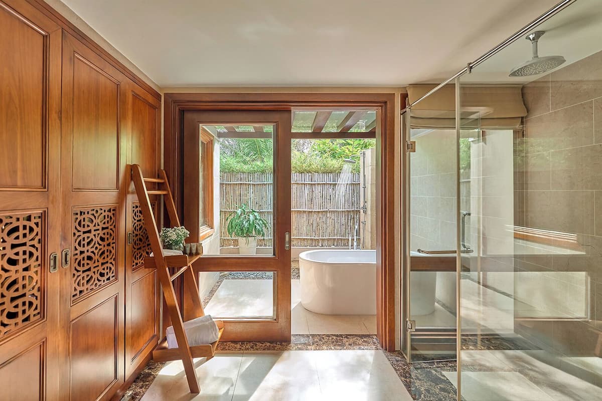 Bathtub, designer toiletries, hair dryer, bathrobes