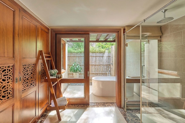Bathtub, designer toiletries, hair dryer, bathrobes