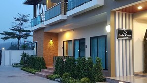 A modern hotel with a two-story structure, a balcony on the upper floor, and a sign indicating it is a 'Smile Resort'. - Smile Resort Thungsong (Thung Song)