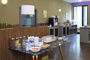 A hotel reception area with a buffet setup, including various food items and beverages. -  Carlsbad INN hotel & apartments (Dalovice)